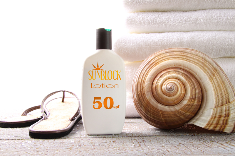 sunblock lotion, sandals, seashell, white towels