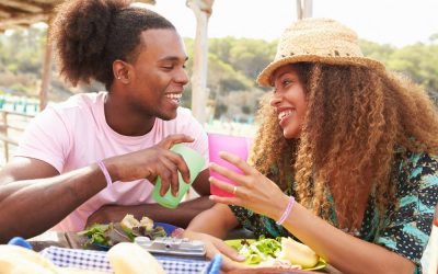 African-American couple outside eating